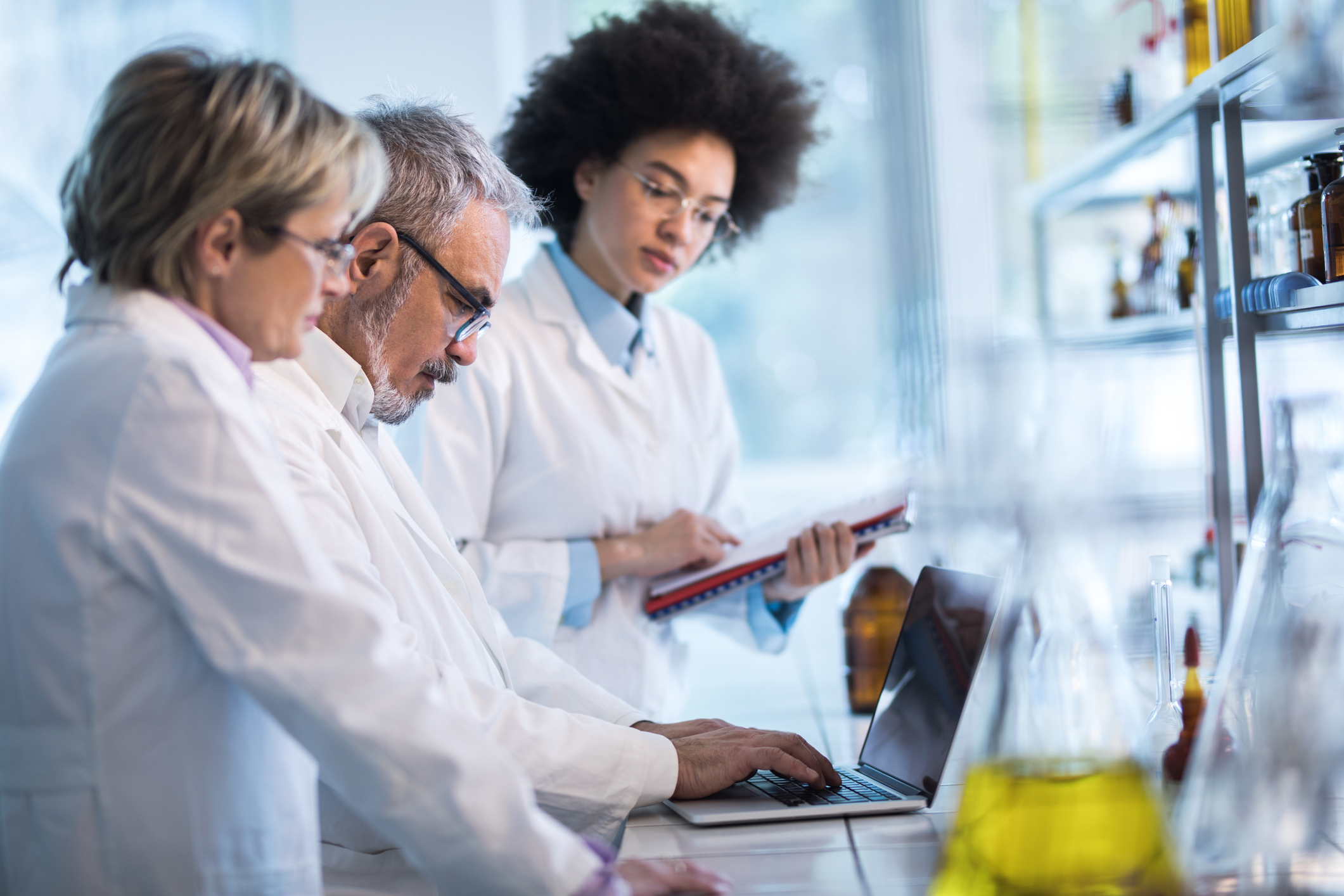 photograph of three scientists in a lab