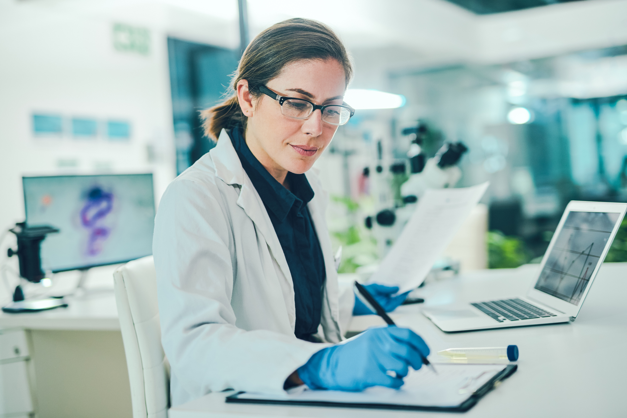 image of a scientist taking notes in a lab