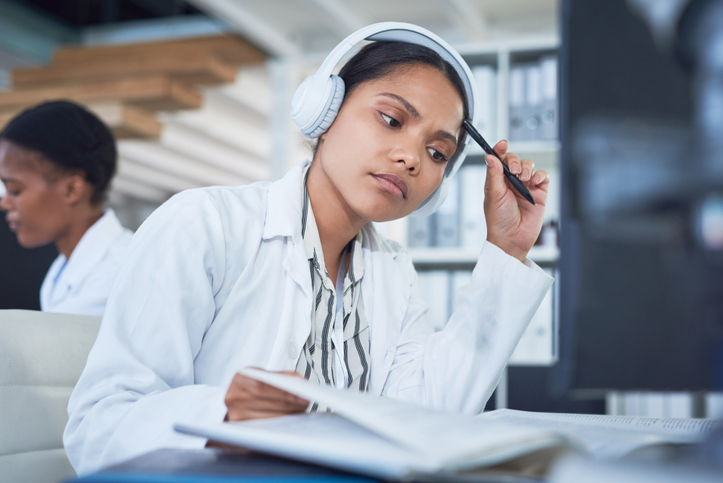 photo of a woman with headphones at a computer