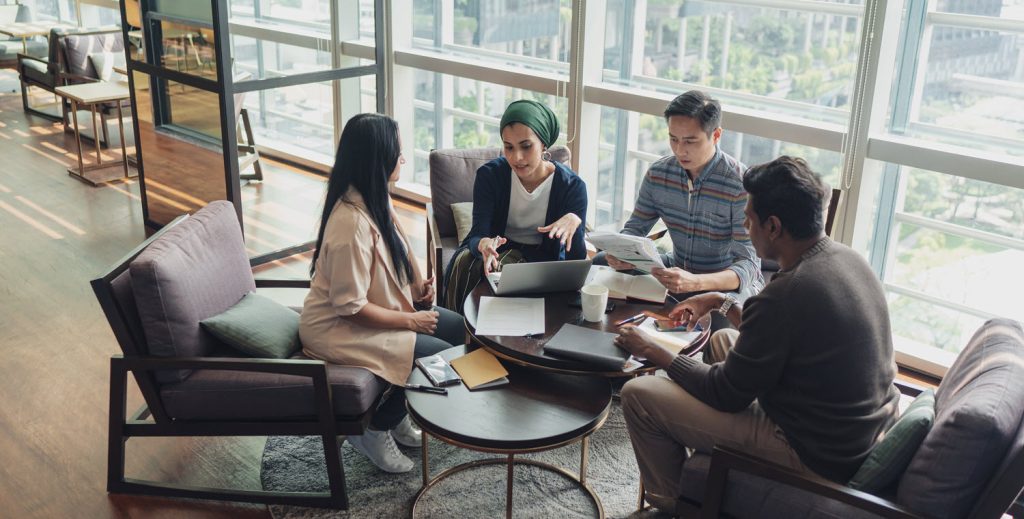 photograph of people around a table collaborating