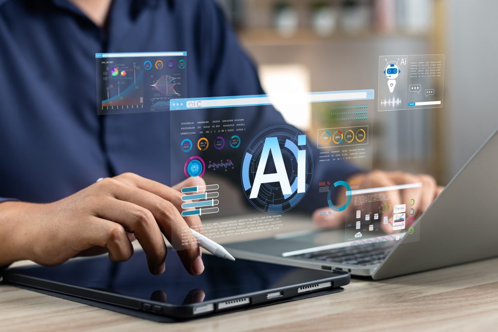 man at desk using AI on laptop