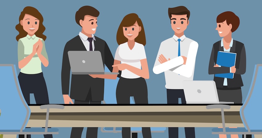 employees standing around desk discussing AI